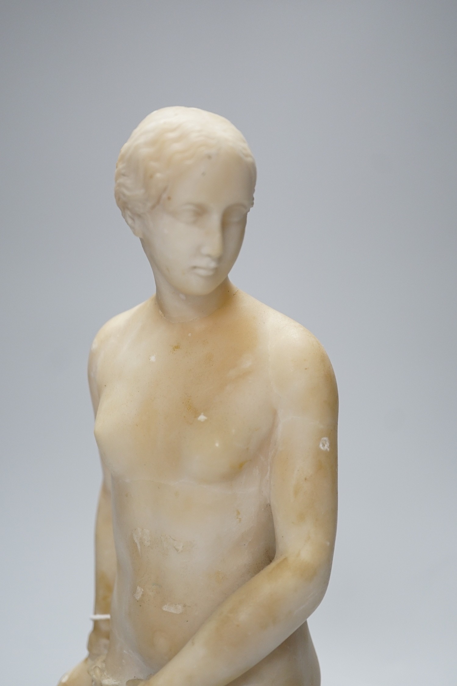A carved alabaster female classical figure, the Greek slave Hiram Powers, 36cms high